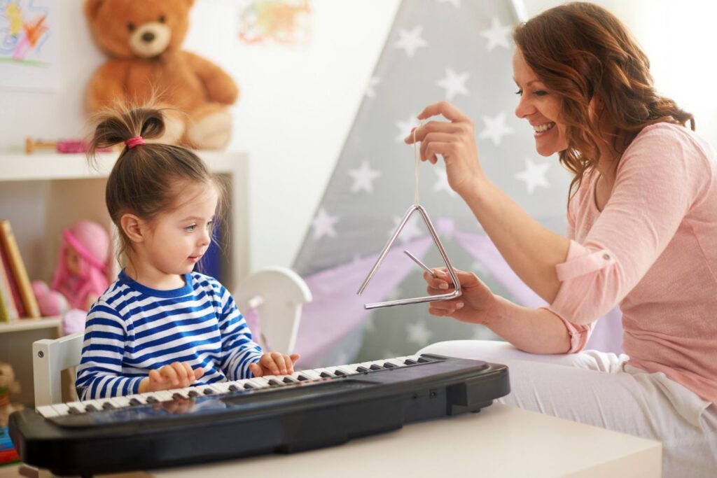 Mother and daughter playing music and singing, enjoying learning music together