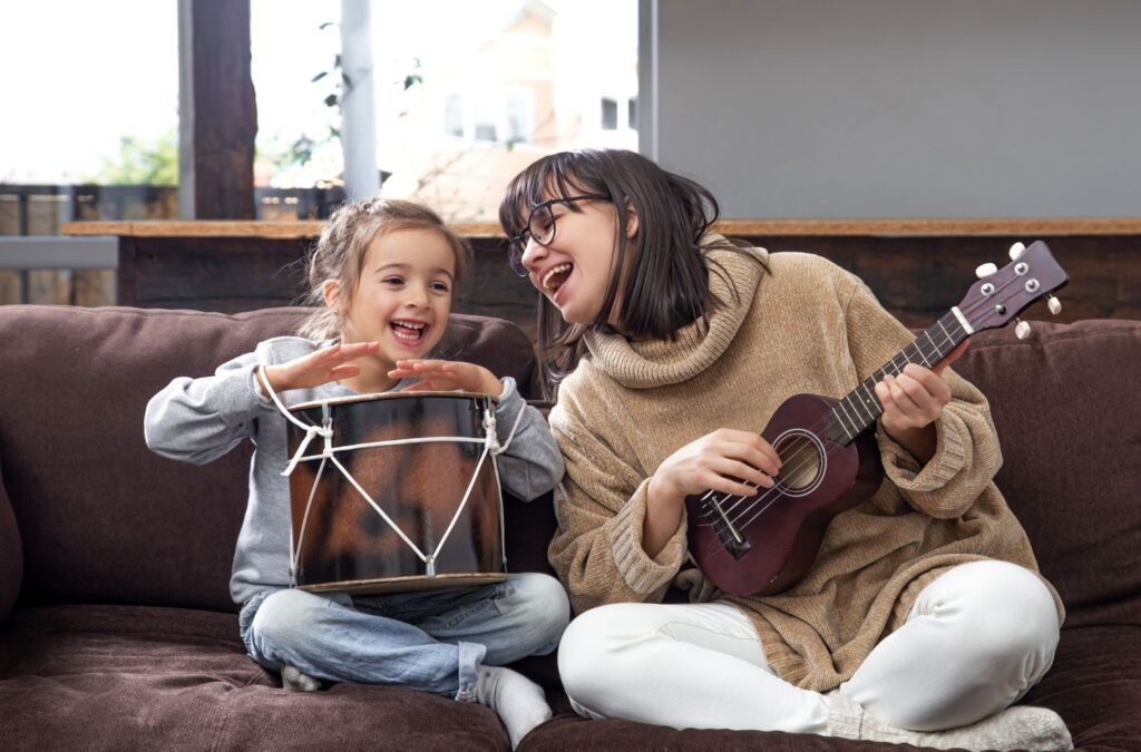 Parent and child enjoying a musical moment together, learning and bonding over music.