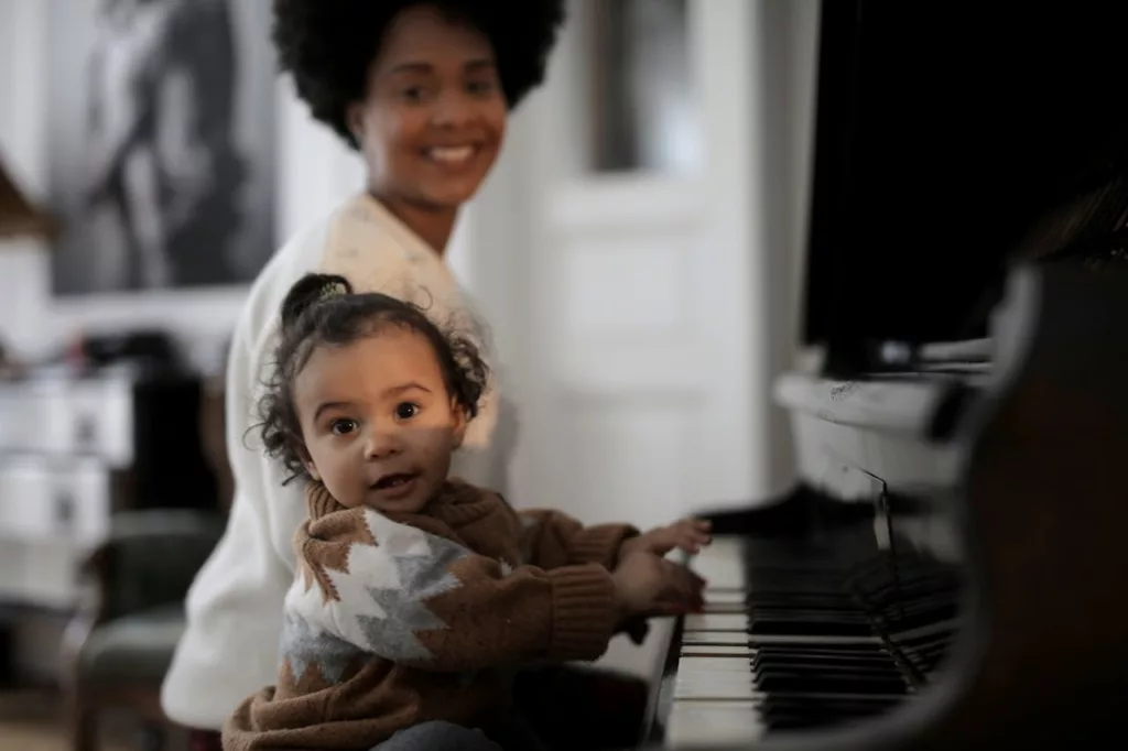 mother and toddler singing and playing music together at home, strengthening bonds through musical exploration.