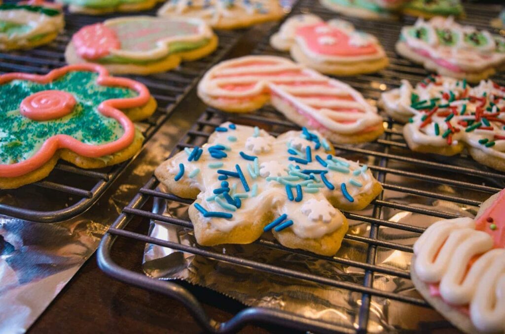 Christmas cookies decorated with frosting and sprinkles, Kid-friendly Christmas cookie decorating ideas.