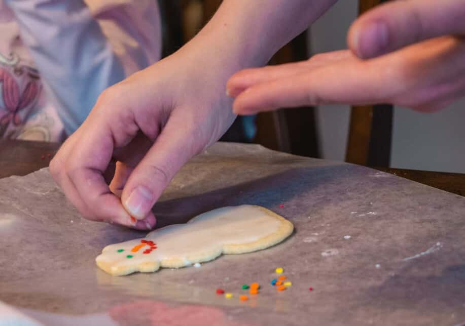 Decorating Christmas cookie with sprinkles